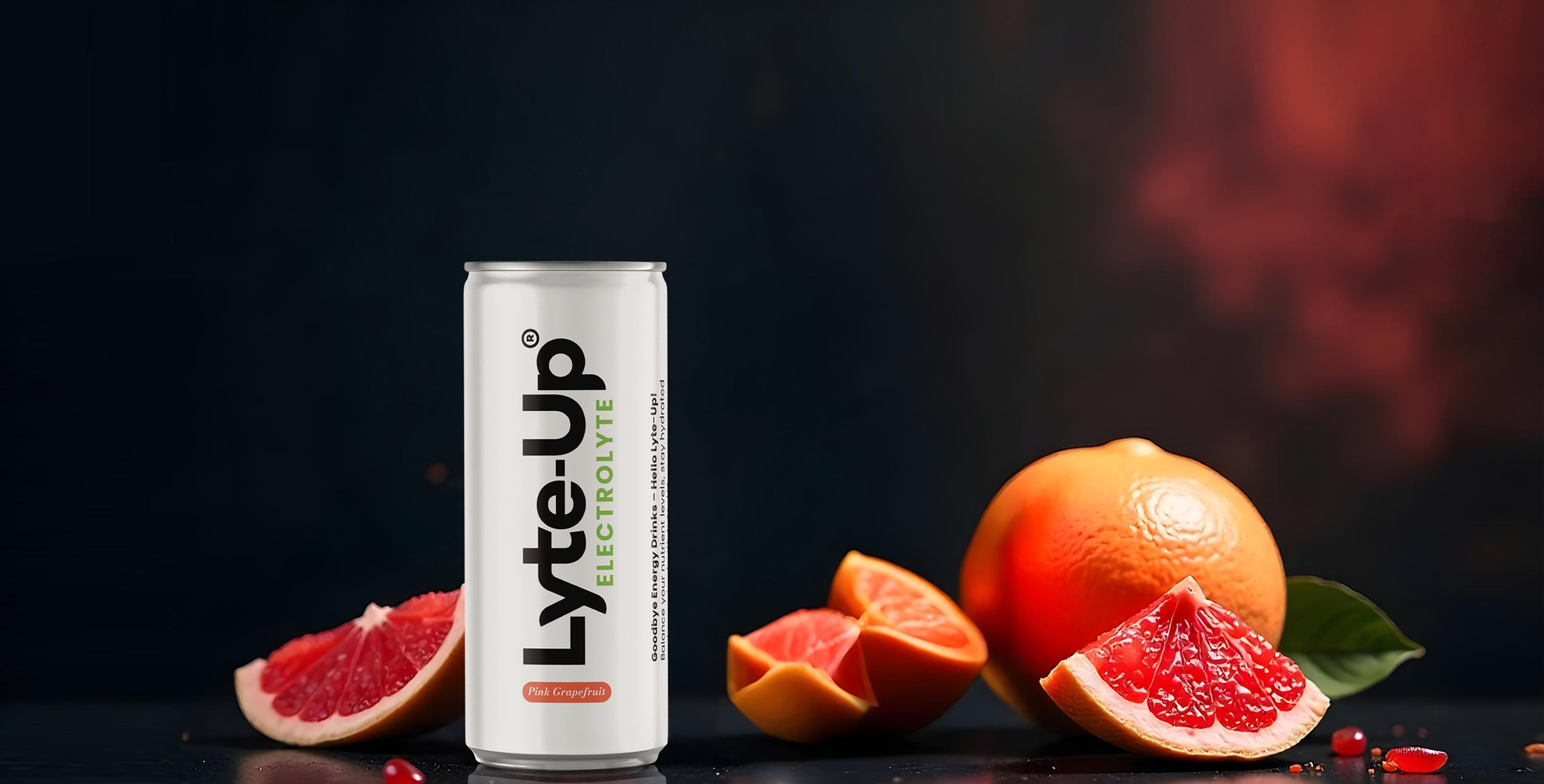 Lyte-Up electrolyte drink can in pink grapefruit flavor, placed beside fresh grapefruit slices on a dark background